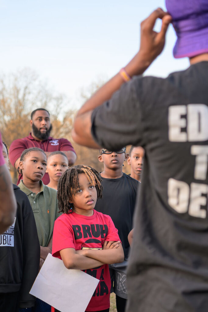 A group of people, featured in a nonprofit directory, stand together in a circle, united by a common cause.