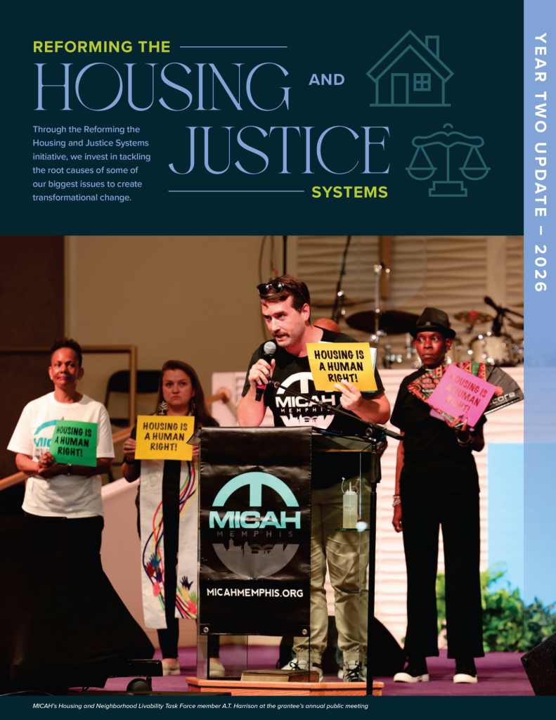 A speaker stands at a podium labeled MICAH Memphis holding a sign reading Housing is a Human Right, with four others holding similar signs on stage during a housing and justice event focused on housing reform and system reform.